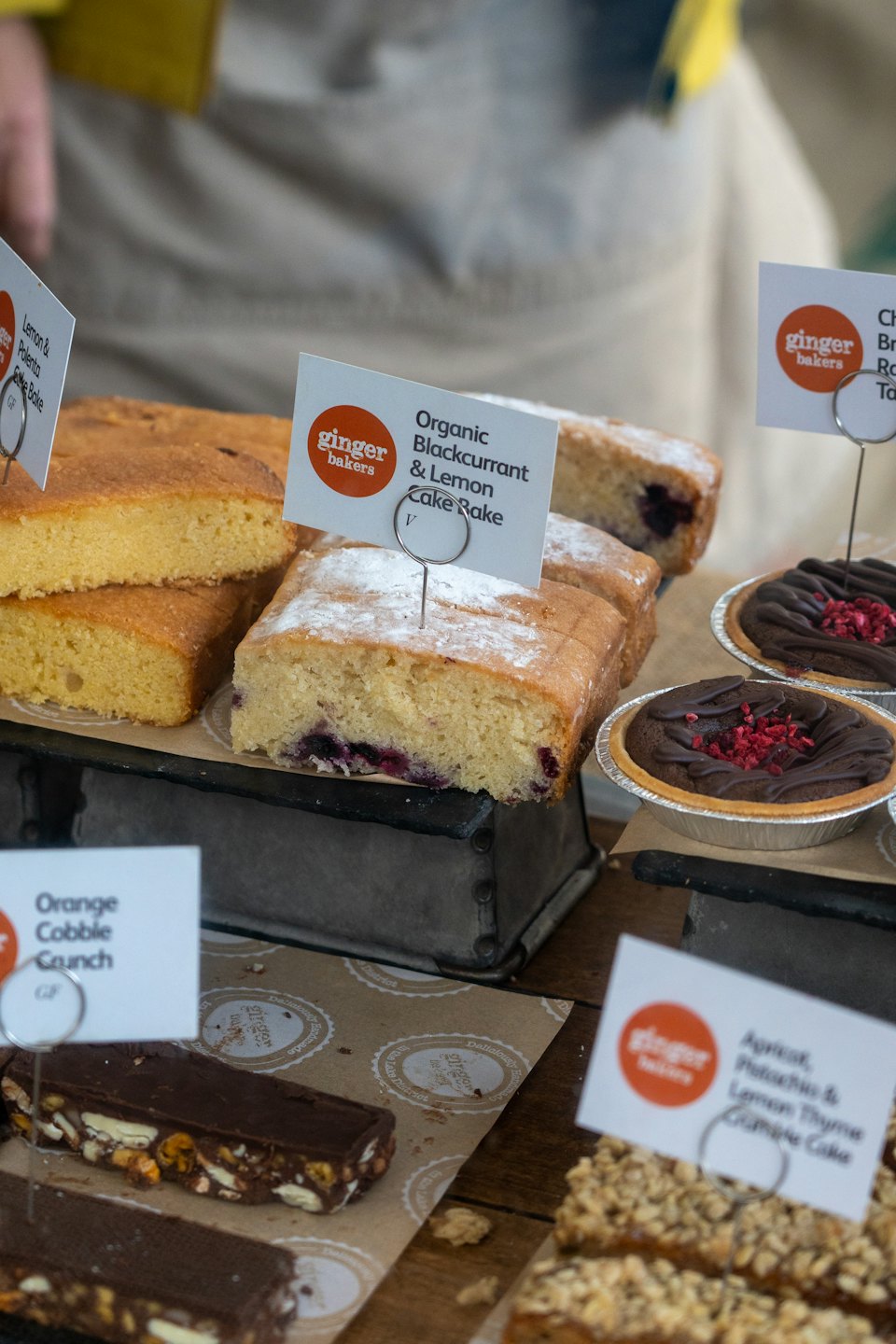Baked goods for sale on market stall trays.